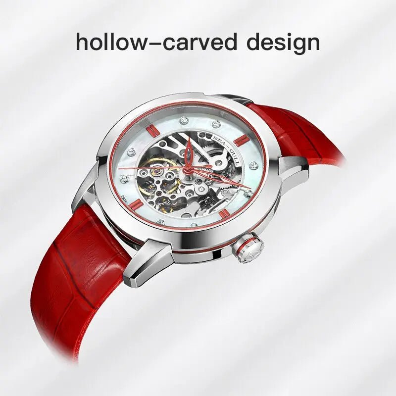 Armbanduhr mit rotem Lederarmband, skelettiertem Zifferblatt mit Hohlgravur und Präzisionszahnrädern