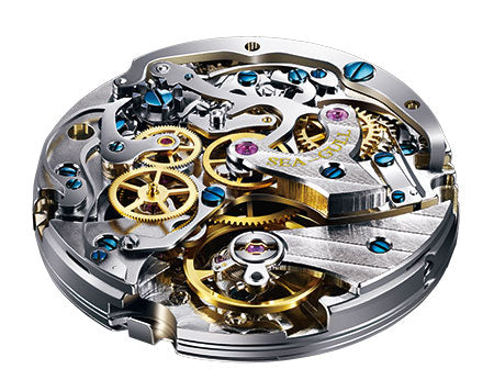 Precision in-house watch movement with gold gears and blue jewels, showcasing intricate mechanical design.
